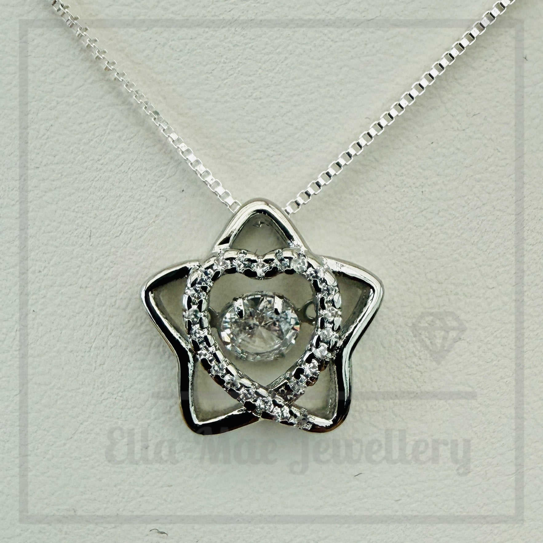 Star shaped pendant with crystal inner heart and dancing inner crystal