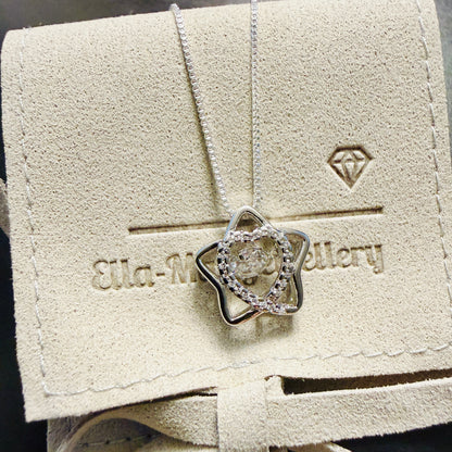 Star shaped pendant with crystal inner heart and dancing inner crystal on luxury gift pouch