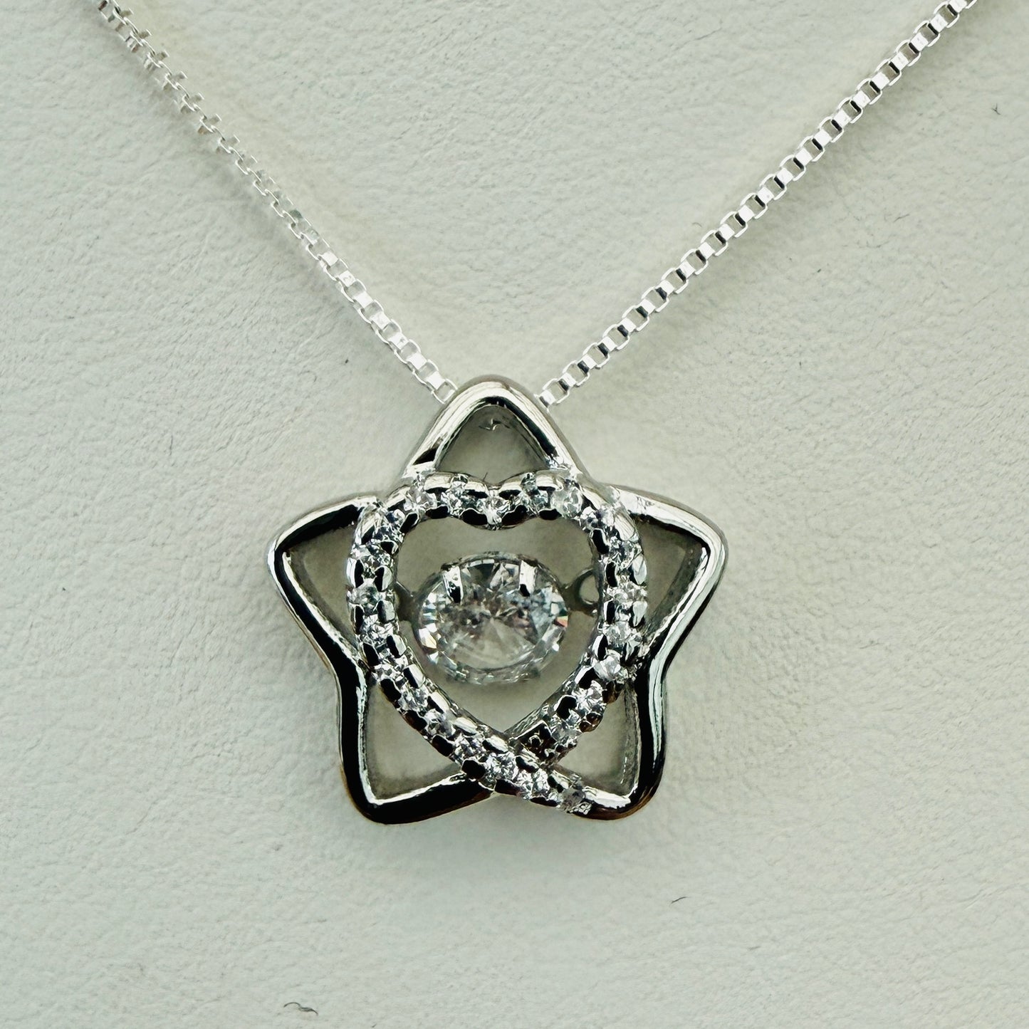 Star shaped silver necklace with crystal inner heart and dancing inner crystal on box chain