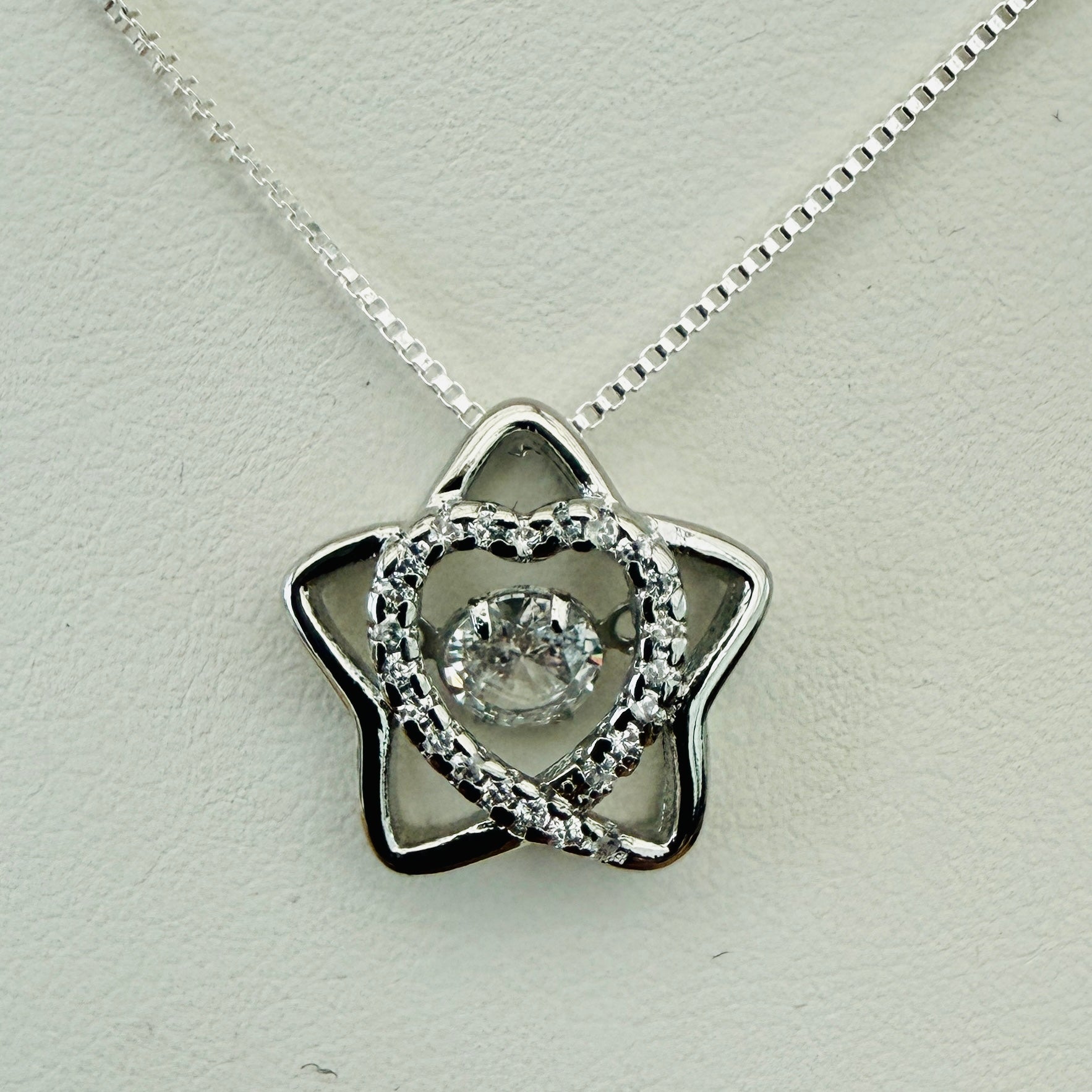 Star shaped silver necklace with crystal inner heart and dancing inner crystal on box chain