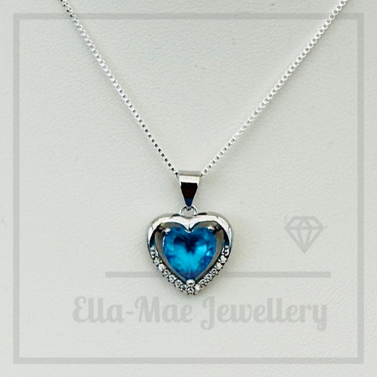 Azure blue heart-shaped crystal pendant on a silver chain with 'Ella-Mae Jewellery' branding.